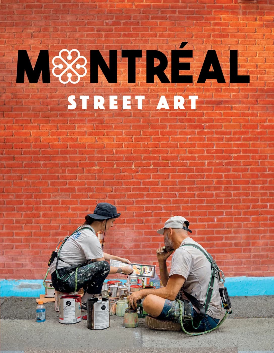 Couverture du livre : deux muralistes assis devant un mur de brique rouge, sous le titre Montréal Street Art.